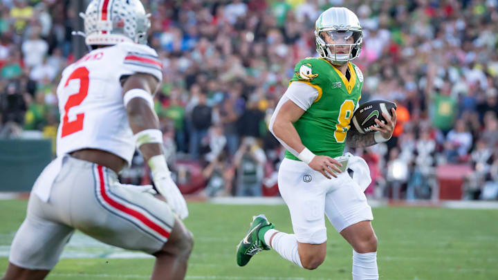 Oregon quarterback Dillon Gabriel scrambles with the ball as the Oregon Ducks face the Ohio State Buckeyes Wednesday, Jan. 1, 2025, in the quarterfinal of the College Football Playoff at the Rose Bowl in Pasadena, Calif.