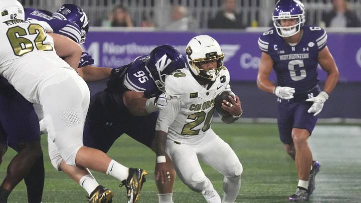 Sep 19, 2026; Evanston, Illinois, USA; Northwestern defensive end Yamil Talib (95) tries to tackle Colorado Buffaloes running back DeKalon Taylor (20) during the first half at Northwestern Medicine Field at Martin Stadium.  Mandatory Credit: David Banks-Imagn Images