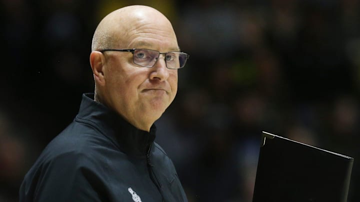 Purdue head coach Dave Shondell signals a play call down court 