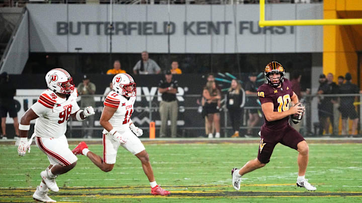 Arizona State Sun Devils quarterback Sam Leavitt (10) is chased by Utah Utes safety Alaka'i Gilman (11) and defensive tackle Dallas Vakalahi (98) in the first half at Mountain America Stadium. Arizona State Sun Devils quarterback Sam Leavitt (10) is chased by Utah Utes safety Alaka'i Gilman (11) and defensive tackle Dallas Vakalahi (98) in the first half at Mountain America Stadium.