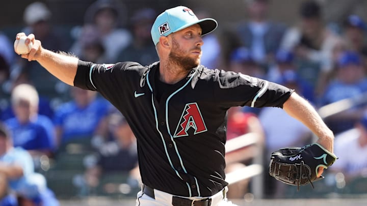 Arizona Diamondbacks starting pitcher Merrill Kelly throws to the Kansas City Royals in the third inning during a spring training game at Salt River Fields at Talking Stick on March 11, 2025.
