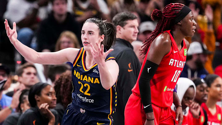 Indiana Fever guard Caitlin Clark (22) reacts after scoring a 3-pointer against Atlanta Dream guard Rhyne Howard (10) on Tuesday, May 20, 2025, during a game between the Indiana Fever and the Atlanta Dream at Gainbridge Fieldhouse in Indianapolis.
