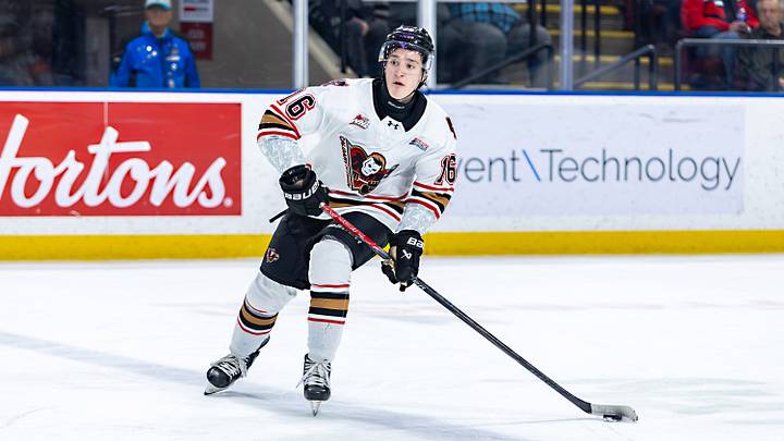KELOWNA, BRITISH COLUMBIA - JANUARY 16: Ben MacBeath #16 of the Calgary Hitmen carries the puck against the Kelowna Rockets at Prospera Place on January 16, 2026 in Kelowna, British Columbia. (Photo by Steve Dunsmoor/Getty Images)