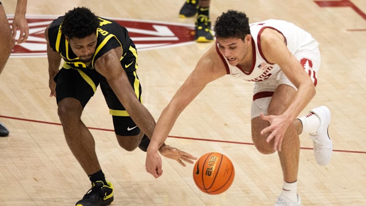 Feb 22, 2024; Stanford, California, USA; Oregon Ducks guard Kario Oquendo (left) and Stanford forward Brandon Angel (right).