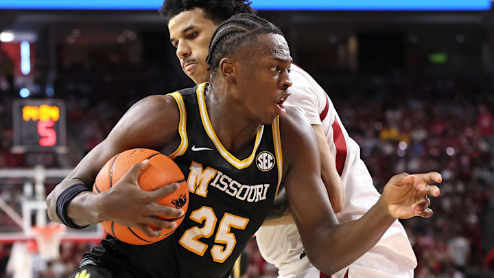 Feb 21, 2026; Fayetteville, Arkansas, USA; Missouri Tigers guard Mark Mitchell (25) drives against Arkansas Razorbacks forward Malique Ewin (12) during the second half at Bud Walton Arena. Arkansas won 94-86. Mandatory Credit: Nelson Chenault-Imagn Images Feb 21, 2026; Fayetteville, Arkansas, USA; Missouri Tigers guard Mark Mitchell (25) drives against Arkansas Razorbacks forward Malique Ewin (12) during the second half at Bud Walton Arena. Arkansas won 94-86. Mandatory Credit: Nelson Chenault-Imagn Images
