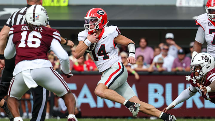 Nov 8, 2025; Starkville, Mississippi, USA; Georgia Bulldogs quarterback  Gunner Stockton (14) runs with the ball against the Mississippi State Bulldogs during the first half at Davis Wade Stadium at Scott Field. Mandatory Credit: Wesley Hale-Imagn Images