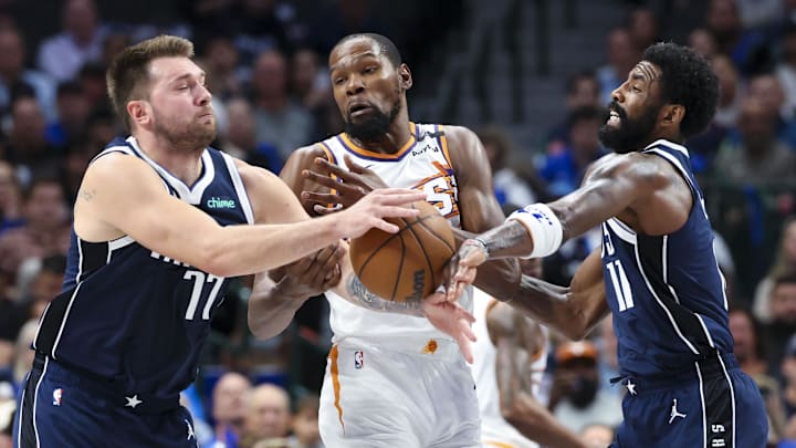 Nov 8, 2024; Dallas, Texas, USA;  Dallas Mavericks guard Luka Doncic (77) and Dallas Mavericks guard Kyrie Irving (11) try to take the ball away from Phoenix Suns forward Kevin Durant (35) during the first quarter at American Airlines Center. Mandatory Credit: Kevin Jairaj-Imagn Images