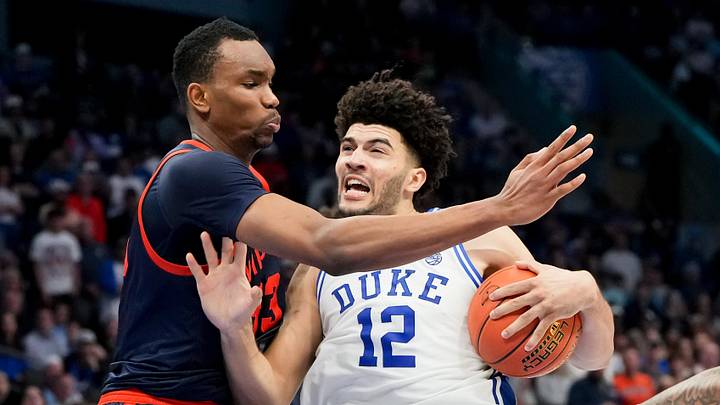 Mar 14, 2026; Charlotte, NC, USA; Duke Blue Devils forward Cameron Boozer (12) goes to the basket against Virginia Cavaliers center Ugonna Onyenso (33) during the men's ACC Conference Tournament Championship at Spectrum Center. Mandatory Credit: Bob Donnan-Imagn Images