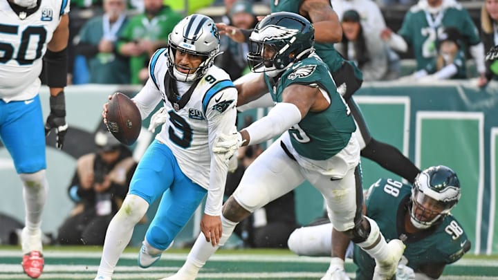 Dec 8, 2024; Philadelphia, Pennsylvania, USA; Carolina Panthers quarterback Bryce Young (9) scrambles out of the end zone under pressure from Philadelphia Eagles linebacker Josh Sweat (19) during the fourth quarter at Lincoln Financial Field.