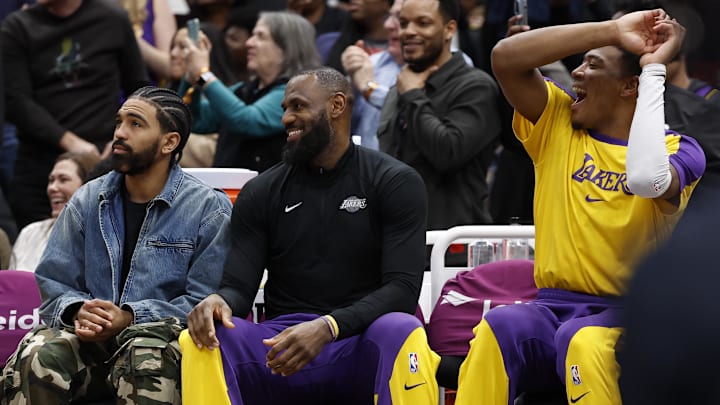 Jan 30, 2025; Washington, District of Columbia, USA; (L-R) Injured Los Angeles Lakers guard Gabe Vincent (7), Lakers forward LeBron James (M), and Lakers forward Rui Hachimura (R) react on the bench after a basket by Los Angeles Lakers guard Bronny James (not pictured) against the Washington Wizards in the fourth quarter at Capital One Arena. Mandatory Credit: Geoff Burke-Imagn Images