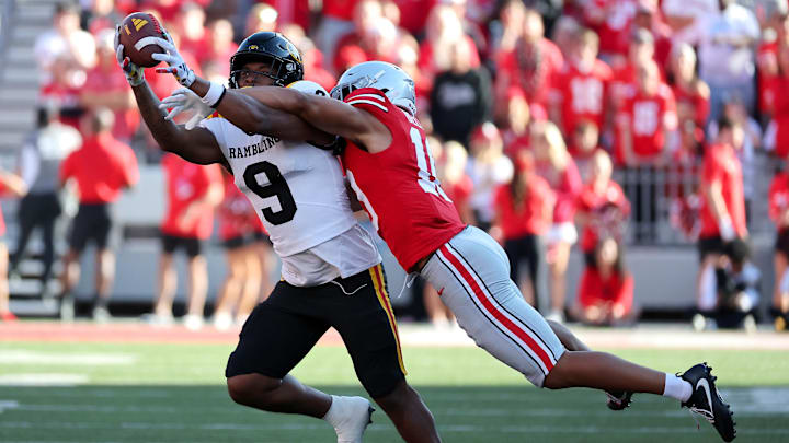 Sep 6, 2025; Columbus, Ohio, USA; Grambling State Tigers tight end Covadis Knighten (9) catches the ball as Ohio State Buckeyes safety Faheem Delane (10) makes the tackle during the third quarter at Ohio Stadium. Mandatory Credit: Joseph Maiorana-Imagn Images