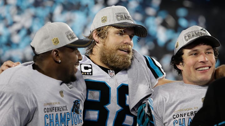 Jan 24, 2016; Charlotte, NC, USA; Carolina Panthers tight end Greg Olsen (88) celebrates with outside linebacker Thomas Davis (58) and middle linebacker Luke Kuechly (59) during the trophy presentation after defeating the Arizona Cardinals during the NFC Championship football game held at Bank of America Stadium. Mandatory Credit: Jeremy Brevard-Imagn Images