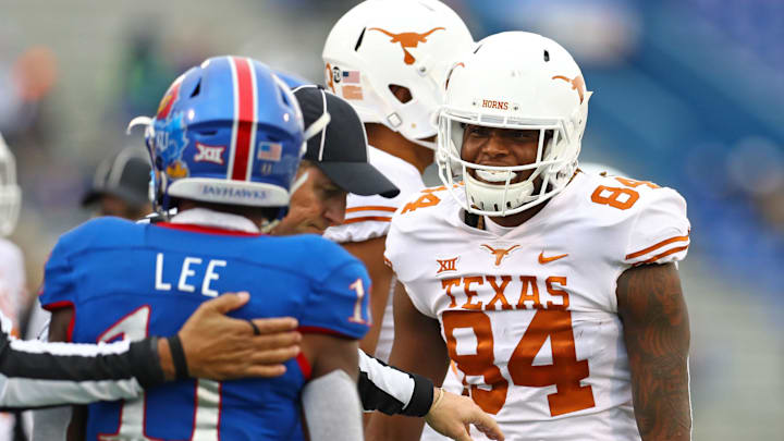 Nov 23, 2018; Lawrence, KS, USA; Texas Longhorns wide receiver Lil'Jordan Humphrey (84) talks to Kansas Jayhawks safety Mike Lee (11) in the second half at Memorial Stadium. Mandatory Credit: Jay Biggerstaff-Imagn Images