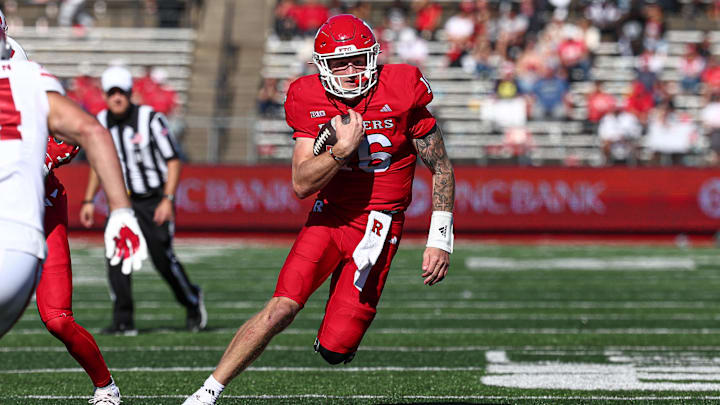 Oct 12, 2024; Piscataway, New Jersey, USA;  Rutgers Scarlet Knights quarterback Athan Kaliakmanis (16) carries the ball against the Wisconsin Badgers pursues during the second half at SHI Stadium. Mandatory Credit: Vincent Carchietta-Imagn Images