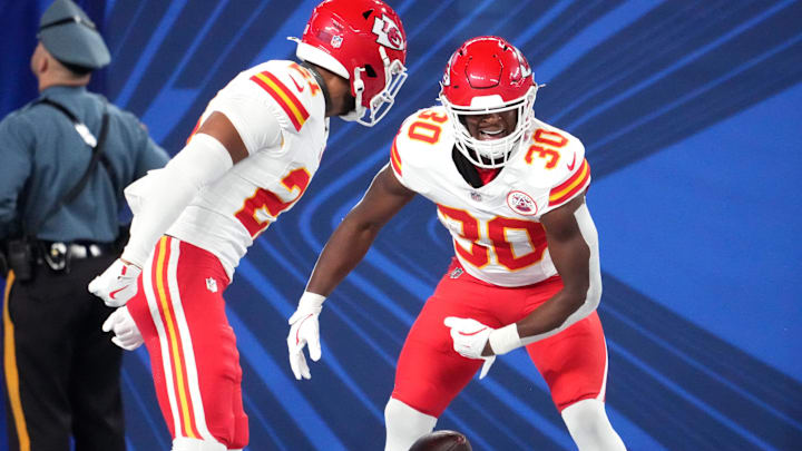 Sep 21, 2025; East Rutherford, New Jersey, USA; Kansas City Chiefs cornerback Christian Roland-Wallace (30) celebrates with safety Jaden Hicks (21) after an interception against the New York Giants in the second quarter at MetLife Stadium. Mandatory Credit: Robert Deutsch-Imagn Images