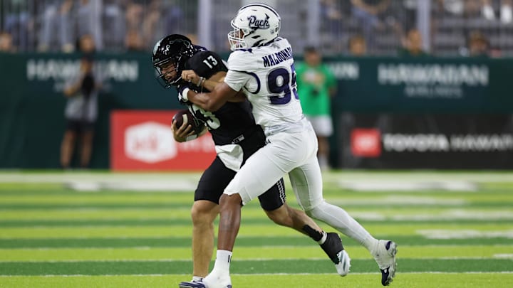 Oct 26, 2024; Honolulu, Hawaii, USA; Nevada Wolf Pack linebacker Jonathan Maldonado (95) shoves Hawaii Rainbow Warriors quarterback Brayden Schager (13) out of bounds during the first quarter of an NCAA college football game at the Clarence T.C. Ching Athletics Complex. Mandatory Credit: Marco Garcia-Imagn Images Oct 26, 2024; Honolulu, Hawaii, USA; Nevada Wolf Pack linebacker Jonathan Maldonado (95) shoves Hawaii Rainbow Warriors quarterback Brayden Schager (13) out of bounds during the first quarter of an NCAA college football game at the Clarence T.C. Ching Athletics Complex. Mandatory Credit: Marco Garcia-Imagn Images
