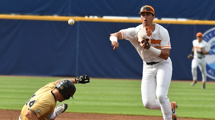 May 22 2024; Hoover, AL, USA; Tennessee shortstop Dean Curley throws to first to complete a double play over the head of Vanderbilt base runner Colin Barczi at the Hoover Met during the SEC Tournament.