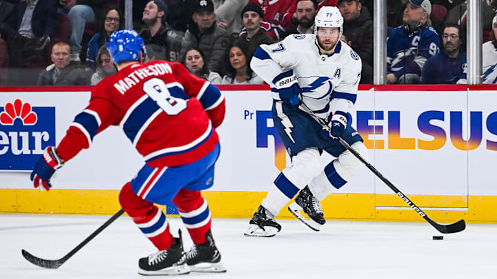 Apr 4, 2024; Montreal, Quebec, CAN; Tampa Bay Lightning defenseman Victor Hedman (77) plays the puck against Montreal Canadiens defenseman Mike Matheson (8) during the second period at Bell Centre. Mandatory Credit: David Kirouac-Imagn Images