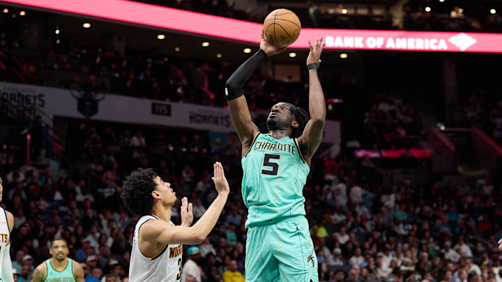 Feb 1, 2025; Charlotte, North Carolina, USA; Charlotte Hornets center Mark Williams (5) shoots over Denver Nuggets guard Julian Strawther (3) during the second half of play at Spectrum Center. Mandatory Credit: Brian Westerholt-Imagn Images