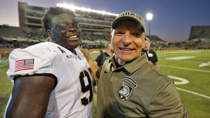 Army Black Knights head coach Jeff Monken celebrates a win with defensive lineman Dre Miller.