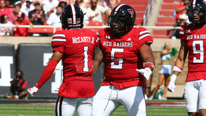 Sep 14, 2024; Lubbock, Texas, USA;  Texas Tech Red Raiders defensive back A.J. McCarty (1) and defensive tackle Quincy Ledet Jr. (5) react after a play against the North Texas Mean Green in the first half at Jones AT&T Stadium and Cody Campbell Field. Mandatory Credit: Michael C. Johnson-Imagn Images