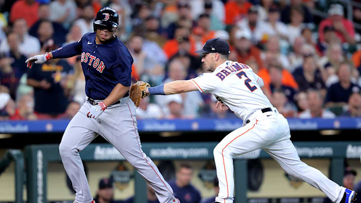 Aug 24, 2023; Houston, Texas, USA; Boston Red Sox third baseman Rafael Devers (11) is tagged out in a rundown by Houston Astros third baseman Alex Bregman (2) during the second inning at Minute Maid Park. Mandatory Credit: Erik Williams-Imagn Images
