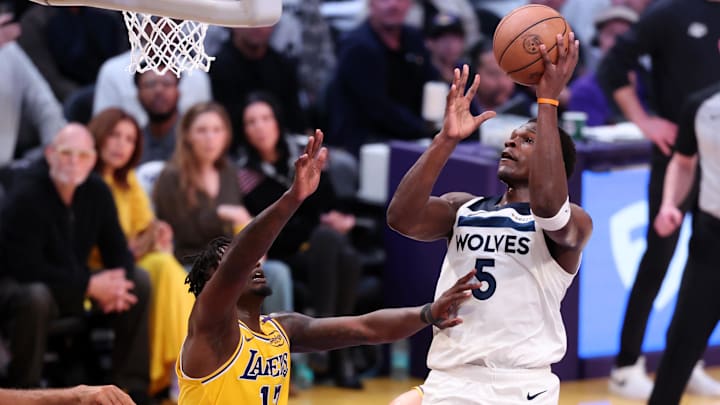 Apr 22, 2025; Los Angeles, California, USA; Minnesota Timberwolves guard Anthony Edwards (5) goes to the basket against Los Angeles Lakers forward Dorian Finney-Smith (17) during the first quarter of game two of first round for the 2024 NBA Playoffs at Crypto.com Arena.