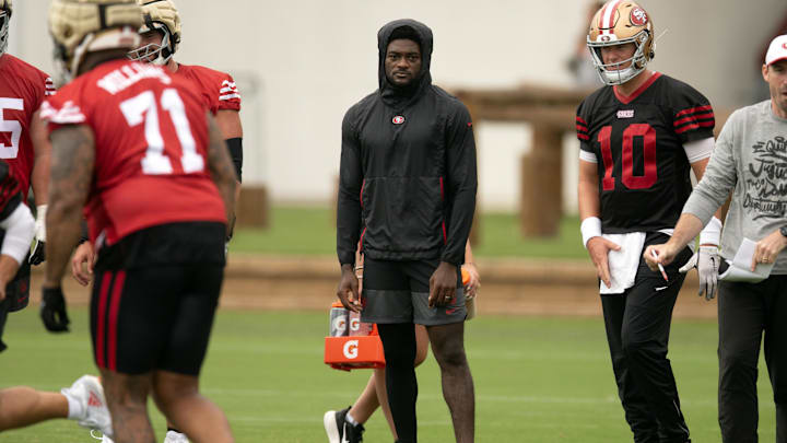 Jul 24, 2025; Santa Clara, CA, USA; San Francisco 49ers wide receiver Brandon Aiyuk (in black hoodie) watches his teammates work out during the second day of training camp. Mandatory Credit: D. Ross Cameron-Imagn Images