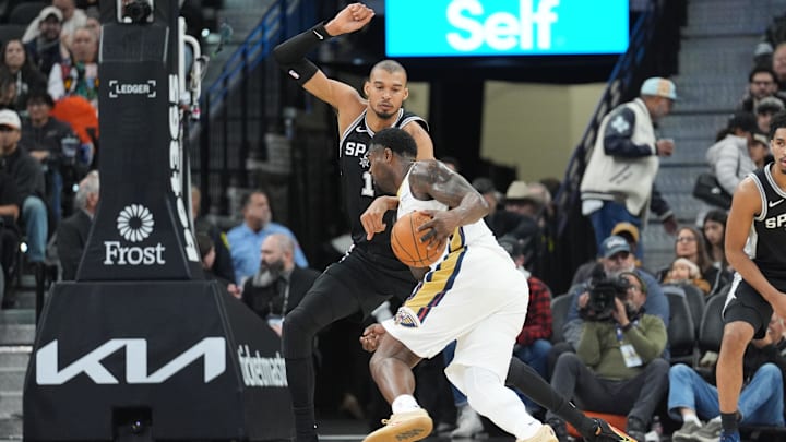 Jan 25, 2026; San Antonio, Texas, USA;  New Orleans Pelicans forward Zion Williamson (1) dribbles in against San Antonio Spurs forward Victor Wembanyama (1) in the first half at Frost Bank Center. Mandatory Credit: Daniel Dunn-Imagn Images