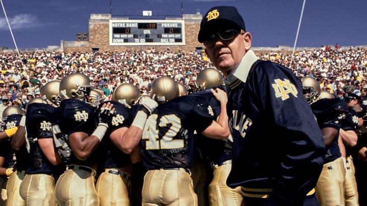 Head coach Lou Holtz of the University of Notre Dame leads his team onto the field prior to the Fighting Irish 52-7 win over Purdue at Notre Dame Stadium in South Bend, Indiana.