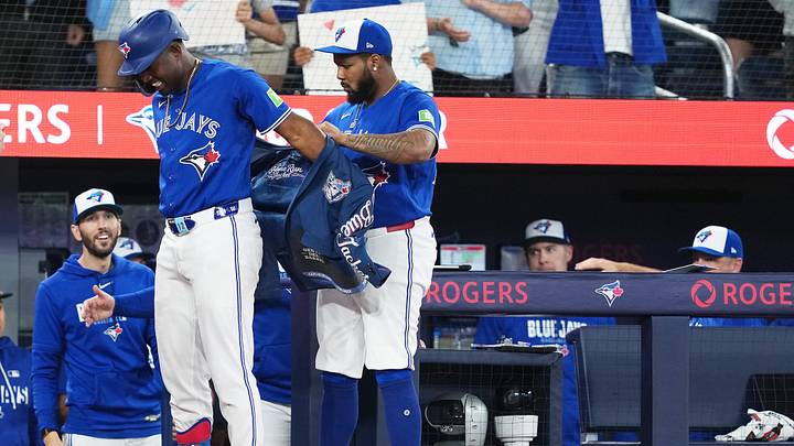 May 26, 2026; Toronto, Ontario, CAN; Toronto Blue Jays right fielder Jesus Sanchez (12) gets the home run jacket from first baseman Vladimir Guerrero Jr. (27) after hitting a grand slam home run against the Miami Marlins during the sixth inning at the Rogers Centre. Mandatory Credit: Nick Turchiaro-Imagn Images