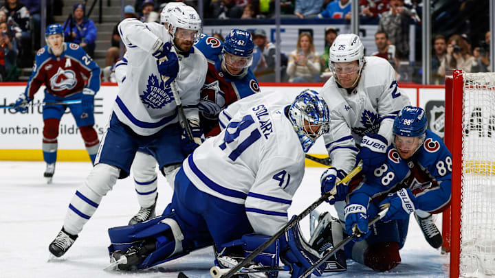 Mar 8, 2025; Denver, Colorado, USA; Toronto Maple Leafs defenseman Brandon Carlo (25) and Colorado Avalanche center Martin Necas (88) battle for the puck behind goaltender Anthony Stolarz (41) as defenseman Oliver Ekman-Larsson (95) and left wing Artturi Lehkonen (62) defend in the second period at Ball Arena. Mandatory Credit: Isaiah J. Downing-Imagn Images