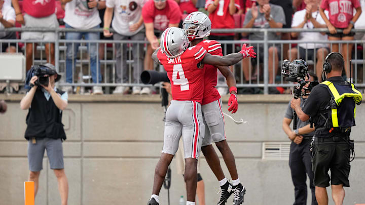 Aug 31, 2024; Columbus, OH, USA; Ohio State Buckeyes wide receiver Jeremiah Smith (4) celebrates a touchdown by wide receiver Carnell Tate (17) during the second half of the NCAA football game against the Akron Zips at Ohio Stadium. Ohio State won 52-6.