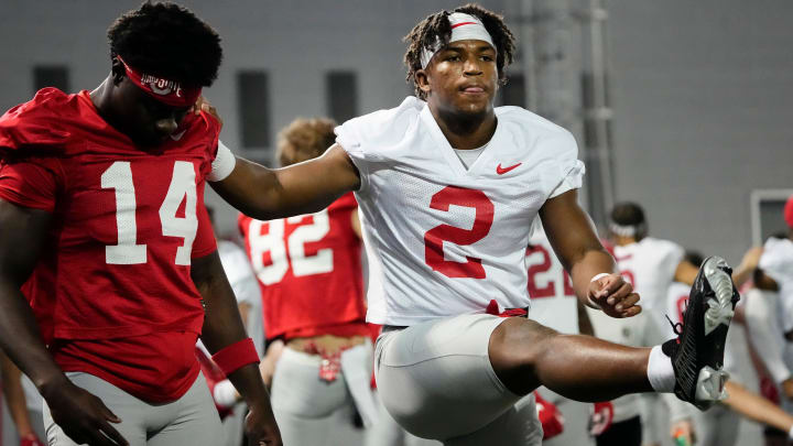 Mar 5, 2024; Columbus, OH, USA; Ohio State Buckeyes safety Caleb Downs (2) stretches with wide receiver Kojo Antwi (14) during the first spring practice at the Woody Hayes Athletic Center.