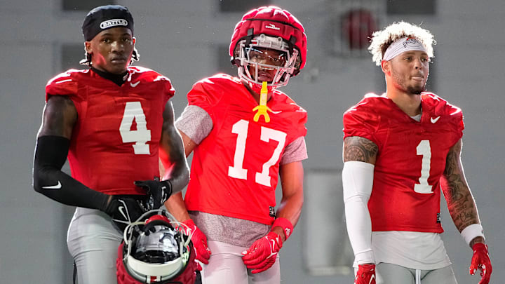Ohio State Buckeyes wide receivers Jeremiah Smith (4), Carnell Tate (17) and Brandon Inniss (1) watch during spring football practice at the Woody Hayes Athletic Center on March 17, 2025.