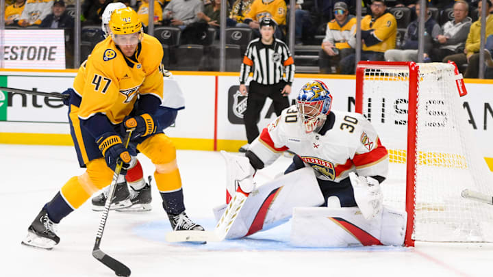 Feb 25, 2025; Nashville, Tennessee, USA;  Nashville Predators right wing Michael McCarron (47) skates with the puck and scores past Florida Panthers goaltender Spencer Knight (30) during the third half at Bridgestone Arena. Mandatory Credit: Steve Roberts-Imagn Images