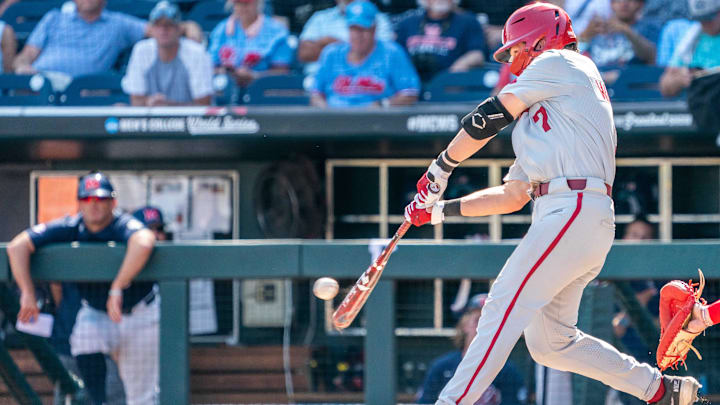 Jun 23, 2022; Omaha, NE, USA; Arkansas Razorbacks third baseman Cayden Wallace (7) lines out to right field to end the sixth inning against the Ole Miss Rebels at Charles Schwab Field. 