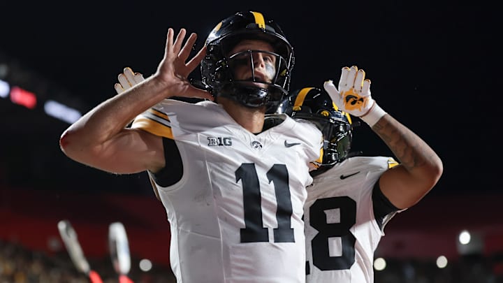 Sep 19, 2025; Piscataway, New Jersey, USA; Iowa Hawkeyes quarterback Mark Gronowski (11) reacts after scoring a rushing touchdown during the fourth quarter against the Rutgers Scarlet Knights at SHI Stadium. Mandatory Credit: Vincent Carchietta-Imagn Images