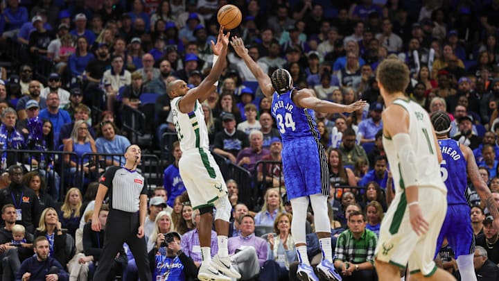 Milwaukee Bucks forward Khris Middleton (22) shoots the ball against Orlando Magic center Wendell Carter Jr. (34) during the second half at KIA Center. Milwaukee Bucks forward Khris Middleton (22) shoots the ball against Orlando Magic center Wendell Carter Jr. (34) during the second half at KIA Center.