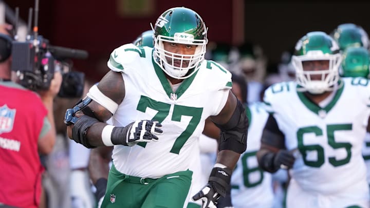 Sep 9, 2024; Santa Clara, California, USA; New York Jets offensive tackle Tyron Smith (77) jogs onto the field before the game against the San Francisco 49ers at Levi's Stadium. Mandatory Credit: Darren Yamashita-Imagn Images