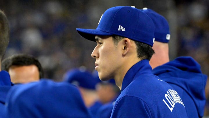 Mar 31, 2025; Los Angeles, California, USA; Los Angeles Dodgers pitcher Roki Sasaki (11) in the dugout during the third inning against the Atlanta Braves at Dodger Stadium. Mandatory Credit: Jayne Kamin-Oncea-Imagn Images