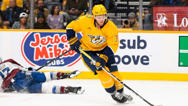 Nov 2, 2024; Nashville, Tennessee, USA;  Nashville Predators defenseman Jeremy Lauzon (3) steals the puck from Colorado Avalanche center Parker Kelly (17)  during the second period at Bridgestone Arena. Mandatory Credit: Steve Roberts-Imagn Images