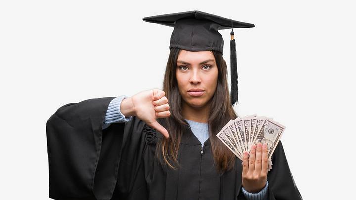Woman wearing a graduation cap and gown, disappointed by money Woman wearing a graduation cap and gown, disappointed by money