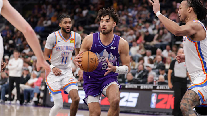 Apr 11, 2025; Salt Lake City, Utah, USA;  Utah Jazz guard Johnny Juzang (33) looks to past the ball during the second half against the Oklahoma City Thunder at Delta Center. Mandatory Credit: Chris Nicoll-Imagn Images