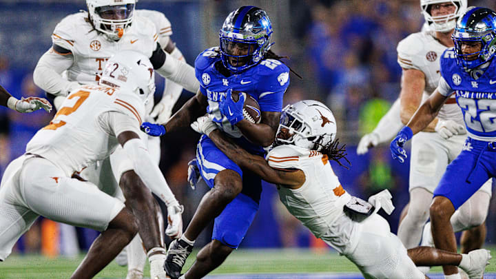 Kentucky Wildcats running back Jason Patterson (26) runs the ball against Texas Longhorns defensive back Jaylon Guilbeau (3) during the fourth quarter, Oct. 18, 2025 at Kroger Field in Lexington, Kentucky.
