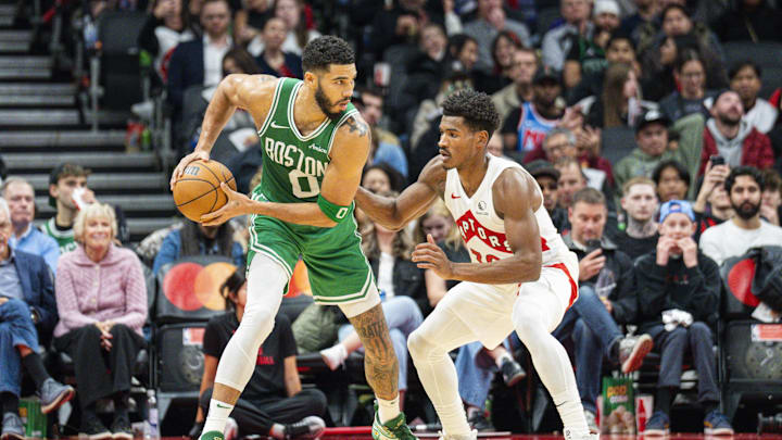 Oct 15, 2024; Toronto, Ontario, CAN;  Boston Celtics forward Jayson Tatum (0) guards the ball against Toronto Raptors guard Ochai Agbaji (30) during the first half at Scotiabank Arena. Mandatory Credit: Kevin Sousa-Imagn Images