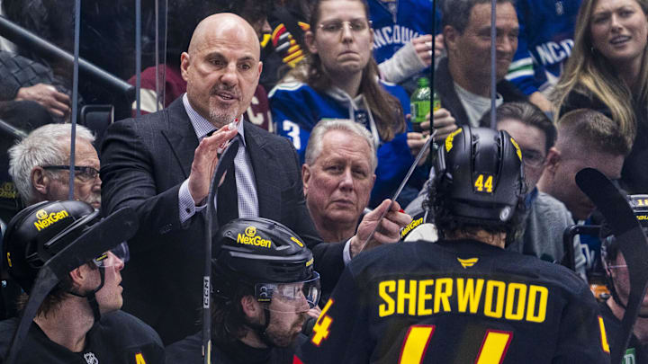 Mar 7, 2025; Vancouver, British Columbia, CAN; Vancouver Canucks head coach Rick Tocchet talks with forward Kiefer Sherwood (44) on the bench against the Minnesota Wild in the third period at Rogers Arena.