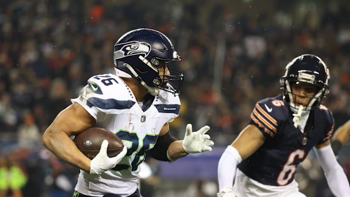Dec 26, 2024; Chicago, Illinois, USA; Seattle Seahawks running back Zach Charbonnet (26) runs for a gain as Chicago Bears cornerback Kyler Gordon (6) defends during the first quarter at Soldier Field. Mandatory Credit: Talia Sprague-Imagn Images Dec 26, 2024; Chicago, Illinois, USA; Seattle Seahawks running back Zach Charbonnet (26) runs for a gain as Chicago Bears cornerback Kyler Gordon (6) defends during the first quarter at Soldier Field. Mandatory Credit: Talia Sprague-Imagn Images