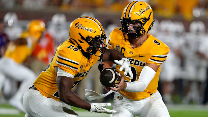 Missouri Tigers quarterback Beau Pribula (9), hands the ball to his running back Ahmad Hardy (29), in a game against the UMass Minutemen this season.