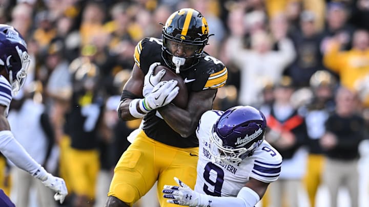 Oct 26, 2024; Iowa City, Iowa, USA; Iowa Hawkeyes running back Kaleb Johnson (2) runs for a 26 yard touchdown against Northwestern Wildcats defensive back Braden Turner (9) during the second quarter at Kinnick Stadium. Oct 26, 2024; Iowa City, Iowa, USA; Iowa Hawkeyes running back Kaleb Johnson (2) runs for a 26 yard touchdown against Northwestern Wildcats defensive back Braden Turner (9) during the second quarter at Kinnick Stadium.
